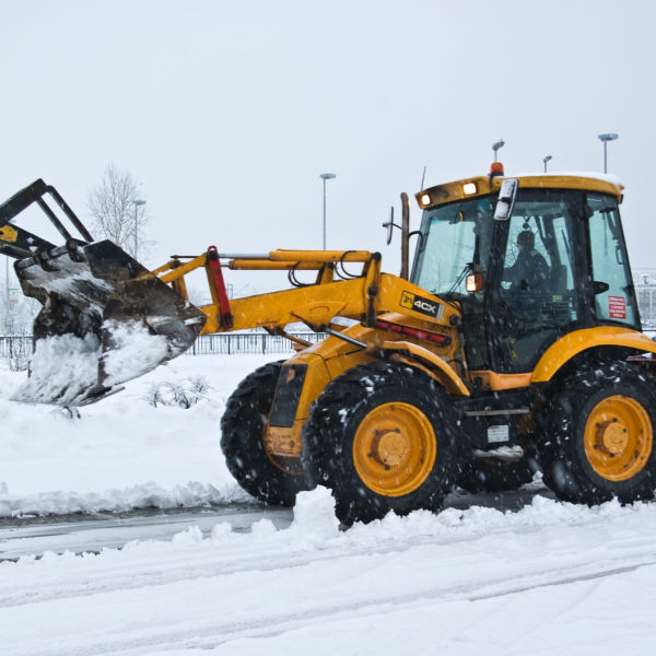 yellow snow plow cleaning a road